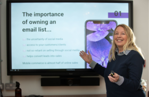 Woman presenting in front of a screen